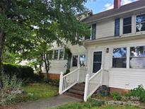Charming exterior view of the home with a covered porch and stairs leading to the entrance at 29 Willow St, Badin, NC 28009