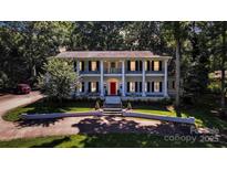 Stately two-story home featuring a red front door and large columns at 327 Saint Andrews Rd, Statesville, NC 28625