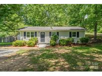 Charming single-story home with a well-maintained lawn and mature trees providing shade at 3724 Patricia Nw Dr, Concord, NC 28027