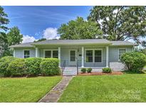 Charming single-story home with a well-maintained lawn, walkway, and inviting front porch at 3729 Woodleaf Rd, Charlotte, NC 28205