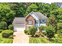Charming two-story home featuring a well-manicured lawn, brick accents, and a two-car garage at 5238 Downing Creek Dr, Charlotte, NC 28269