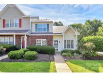 Charming townhome with manicured landscaping, walkway, and inviting entrance at 5980 Cougar Ln, Charlotte, NC 28269