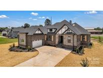 Beautiful two-story home featuring brick and stone accents, with a two-car garage and manicured front yard at 106 Kelly Marie Ct, Kings Mountain, NC 28086