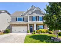Charming two-story home with stone accents, a two-car garage, and manicured landscaping in a desirable neighborhood at 1325 Grantwood Nw Ave, Concord, NC 28027