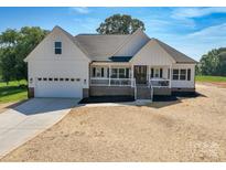 Charming new construction home featuring a welcoming front porch and attached two car garage at 133 Harbourtown Dr, Kings Mountain, NC 28086