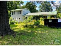 Two story home with a lawn and landscaping that needs some attention at 32891 Nc 49 Hwy, New London, NC 28127