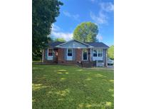 Charming brick home with blue shutters and a well-manicured lawn, perfect for outdoor activities at 3774 Seaman Dr, Charlotte, NC 28217