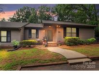 Charming single-story home features mature trees, and a cozy entrance with well-manicured landscaping at 407 Sweetgum Dr # B, Fort Mill, SC 29715