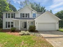 Charming two-story home with a well-maintained lawn and attached two-car garage at 424 Mallard Dr, Pineville, NC 28134