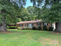 Charming brick ranch home featuring mature trees and a well-maintained lawn at 452 Mcneil St, Gastonia, NC 28054