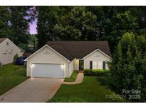 Charming single-story home boasts an attached garage and a well-manicured lawn at 5221 Javitz Rd, Charlotte, NC 28216