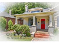Charming two-story home featuring a welcoming front porch and a vibrant red front door at 524 W Horah St, Salisbury, NC 28144