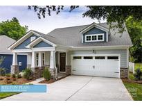 Charming home featuring stone accents, a two-car garage, and a welcoming front porch at 608 Banter Ln # 31, Cramerton, NC 28032