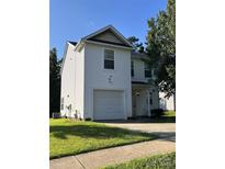Charming two-story home featuring a garage, well-maintained lawn, and traditional white siding at 6130 Sid Crane Dr, Charlotte, NC 28216