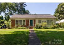 Charming single-story home featuring a brick facade and a well-maintained front lawn at 801 Fugate Ave, Charlotte, NC 28205