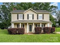 Charming two-story home with a welcoming front porch and manicured lawn at 920 Manor Dr, Kings Mountain, NC 28086