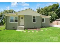 Charming home featuring a well-maintained lawn and neutral, painted brick exterior at 111 Berry St, Chester, SC 29706