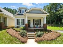 Charming home featuring a cozy front porch, well-maintained landscaping, and classic architectural details at 11359 Deer Ridge Ln, Charlotte, NC 28277