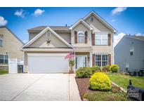 Charming two-story home with a well-manicured lawn, a two car garage, and inviting curb appeal at 115 Morrocroft Ln, Mooresville, NC 28117