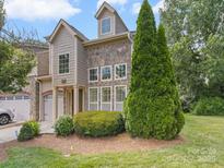 Charming exterior with stone and shingle accents, lush landscaping, and a well-maintained front yard at 1169 Stuarts Landing Dr, Cramerton, NC 28032