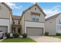 Two-story home with attached garage, neutral siding, well-maintained lawn and landscaping at 14027 Clayborn St, Midland, NC 28107