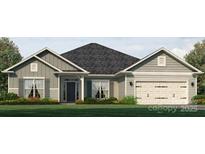 Charming one-story home featuring a two-car garage and manicured landscaping for a welcoming curb appeal at 1445 Mocksville Hwy # 26, Statesville, NC 28625