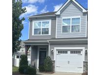Charming two-story home featuring gray siding, a white garage door, and a well-maintained landscaped yard at 15005 Savannah Hall Dr # 72, Charlotte, NC 28273