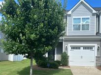 Charming home with a two-car garage, manicured lawn, and mature tree in a well-maintained community at 15005 Savannah Hall Dr # 72, Charlotte, NC 28273