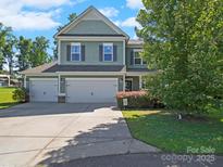 Charming two-story home with a three car garage and beautiful landscaping at 159 Autumn Mist Rd, Statesville, NC 28677
