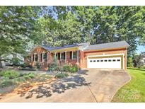 Charming brick home with a two-car garage and a well-maintained front yard at 16509 Kimbolten Dr, Huntersville, NC 28078