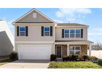 Charming two-story home with attached garage, stone accents, and well-maintained lawn at 221 Brenett Francis Ct, Charlotte, NC 28214