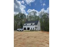 Charming two-story home with a grey exterior, black roof, and a spacious two-car garage on a sprawling lot at 237 Mariposa Rd, Stanley, NC 28164