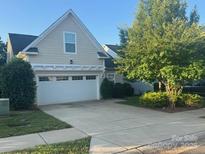 Charming home featuring a two-car garage, well-maintained lawn, and mature landscaping providing curb appeal at 24604 Blue Heron Cir, Lancaster, SC 29720