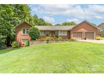 Charming single-story brick home with a well-manicured lawn and a two-car attached garage at 7029 Forest Hills Dr # 38, Denver, NC 28037