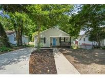 Charming single-Gathering home featuring a bright blue front door and inviting front porch with a newly paved driveway at 909 Gibbons St, Gastonia, NC 28052