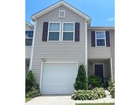 Inviting two-story home with a one-car garage and well-manicured landscaping at 9608 Brackenview Ct, Charlotte, NC 28214
