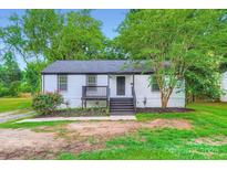 Charming single-story home with freshly painted exterior, landscaping, and inviting front porch at 1224 E Woodlawn Rd, Charlotte, NC 28209