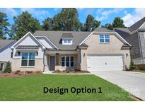 Charming brick home featuring a well-manicured lawn, attached two-car garage, and inviting curb appeal at 1630 Riddle Ext, Clover, SC 29710
