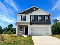 Charming two-story home with a two-car garage, stone accents, and a well-maintained front yard at 217 Lake George Dr, Shelby, NC 28152