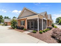 Charming brick home with a screened-in porch and beautifully landscaped yard at 2484 Early Richmond Ct, Denver, NC 28037