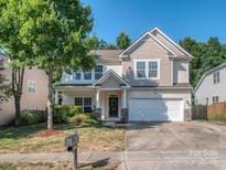 Charming two-story home with a well-manicured lawn and a two-car garage at 3511 Dominion Green Dr, Charlotte, NC 28269