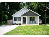 Charming home with a well-maintained lawn, a covered front porch, and a modern exterior at 506 Broadway Ct, Statesville, NC 28677