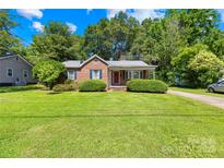 Charming brick home with a well-manicured front lawn and covered porch, creating a welcoming curb appeal at 506 Gold St, Shelby, NC 28150