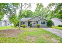 Charming single-story home with a well-maintained lawn, inviting entrance, and mature trees at 5424 Amado St, Charlotte, NC 28215