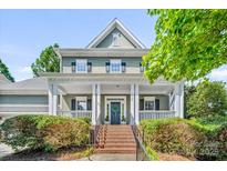 Charming two-story home with a welcoming front porch and well-manicured landscaping at 5728 Mantario Dr, Charlotte, NC 28269