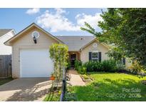 Charming home with a well-manicured lawn, attached garage, and sidewalk at 5806 Autumn Trace Ln, Indian Trail, NC 28079