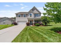 Charming two-story home featuring a well-manicured lawn and a two-car garage at 7129 Dove Field Ln, Fort Mill, SC 29707