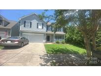 Charming two-story home featuring a well-maintained lawn, a two car garage, and a welcoming front porch at 7218 Cascading Pines Dr, Fort Mill, SC 29708