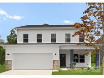Charming two-story home featuring a pristine white exterior, attached garage, and lovely front yard landscaping at 8032 Joy Crossing Ln, Charlotte, NC 28214
