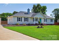 Charming one-story home with well-maintained lawn, landscaping, and blue front door at 106 Abbey Cir, Salisbury, NC 28147